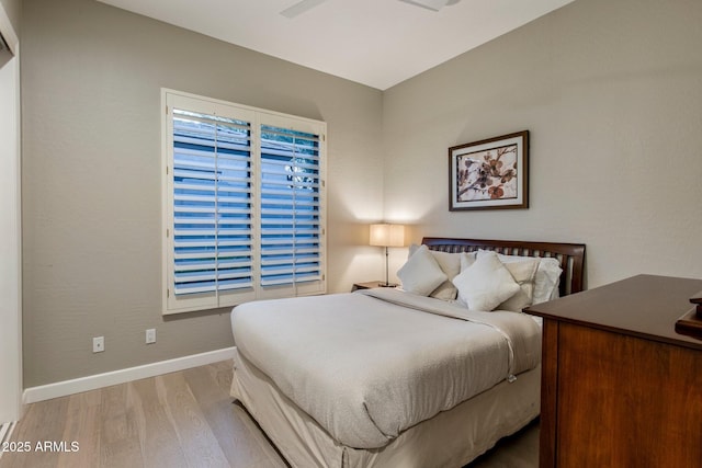 bedroom with baseboards and wood finished floors