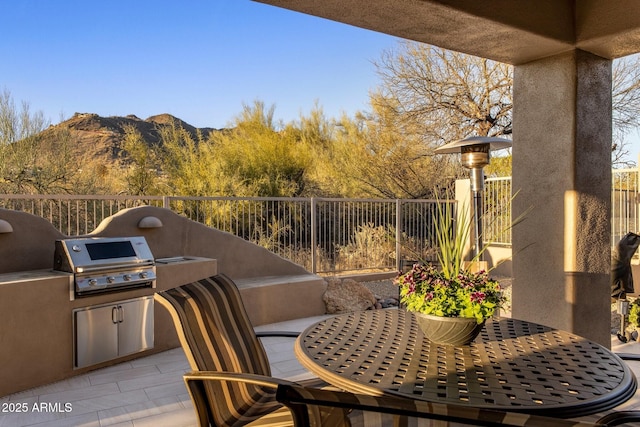 view of patio / terrace with outdoor dining space, fence, and area for grilling