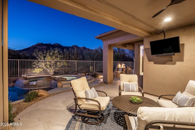 view of patio / terrace with an outdoor hangout area, a fenced backyard, a mountain view, and a fenced in pool