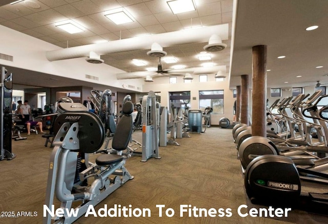 exercise room with a drop ceiling, carpet flooring, and visible vents