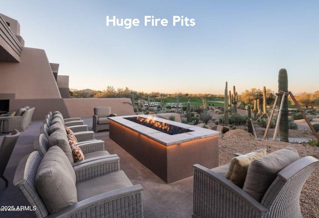 view of patio featuring an outdoor living space with a fire pit