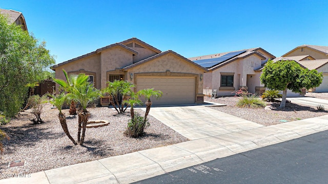1384 S 222nd Ln, Buckeye, AZ 85326 - ranch-style house with stucco siding, an attached garage, concrete driveway, and solar panels