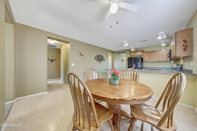 1384 S 222nd Ln, Buckeye, AZ 85326 - dining room with baseboards and ceiling fan