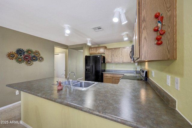 1384 S 222nd Ln, Buckeye, AZ 85326 - kitchen featuring black appliances, a peninsula, and dark countertops