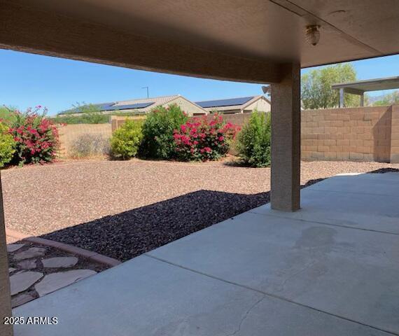 1384 S 222nd Ln, Buckeye, AZ 85326 - fenced backyard with a patio area