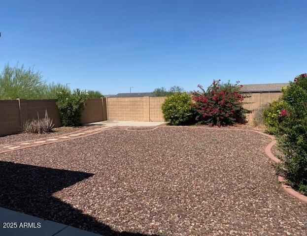 1384 S 222nd Ln, Buckeye, AZ 85326 - fenced backyard featuring a patio