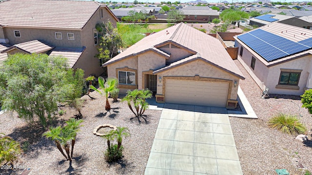 1384 S 222nd Ln, Buckeye, AZ 85326 - view of front of home featuring an attached garage, stucco siding, concrete driveway, and a residential view