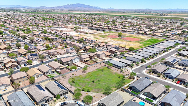 1384 S 222nd Ln, Buckeye, AZ 85326 - aerial view of property and surrounding area featuring a mountain backdrop and nearby suburban area