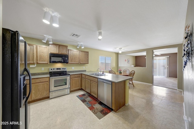 1384 S 222nd Ln, Buckeye, AZ 85326 - kitchen featuring black appliances, a peninsula, ceiling fan, light floors, and light countertops