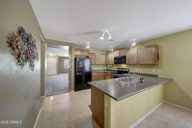 1384 S 222nd Ln, Buckeye, AZ 85326 - kitchen with black appliances, a peninsula, and dark countertops