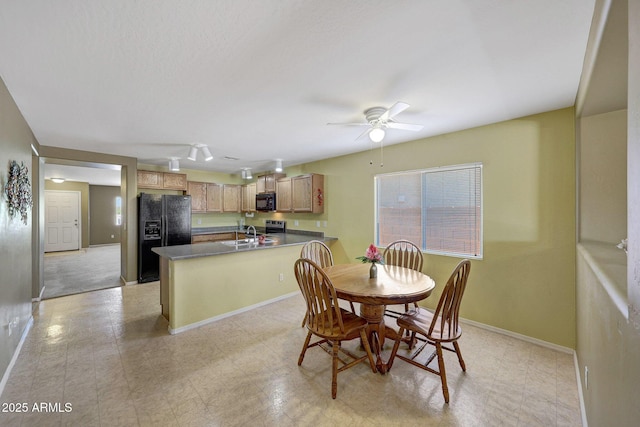 1384 S 222nd Ln, Buckeye, AZ 85326 - dining room featuring ceiling fan and baseboards