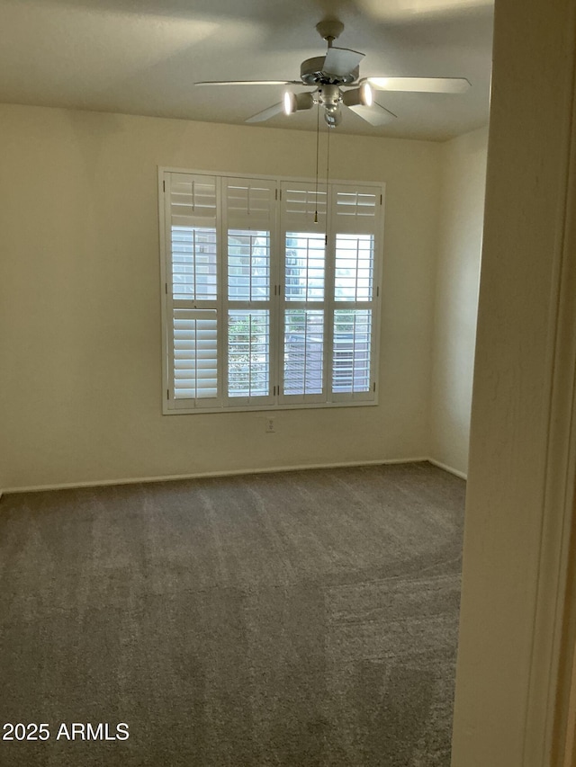 empty room featuring carpet and ceiling fan