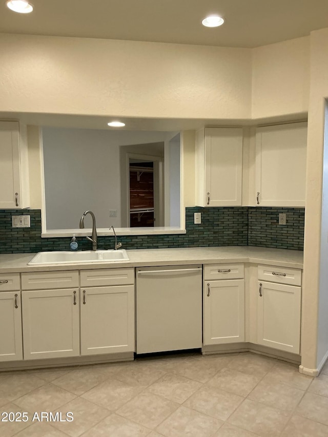 kitchen with a sink, white cabinetry, light countertops, and dishwasher