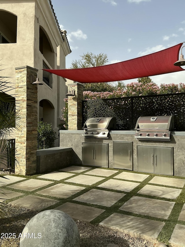 view of patio / terrace featuring exterior kitchen and grilling area