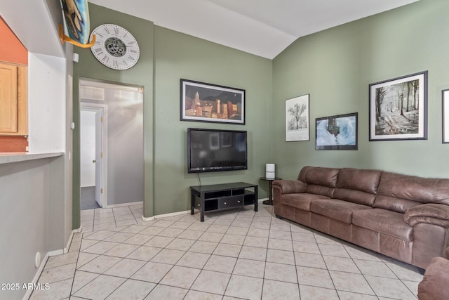 living room featuring lofted ceiling, baseboards, and light tile patterned flooring