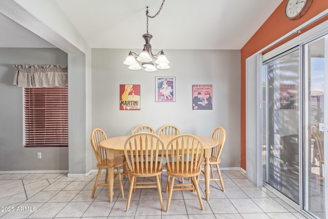 dining room with baseboards, an inviting chandelier, and light tile patterned floors