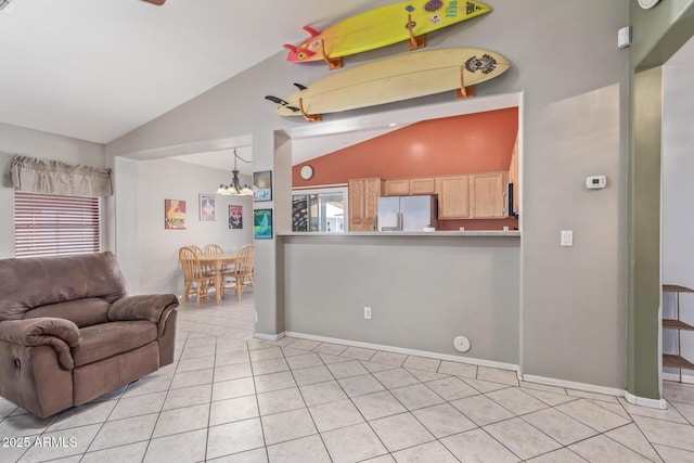 living room with light tile patterned flooring, vaulted ceiling, and plenty of natural light