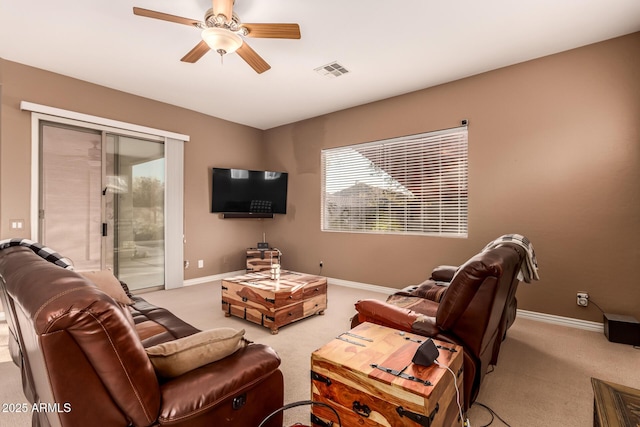 carpeted living room featuring ceiling fan