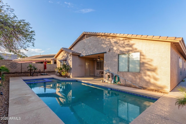 rear view of property featuring a fenced in pool, a patio area, and ceiling fan