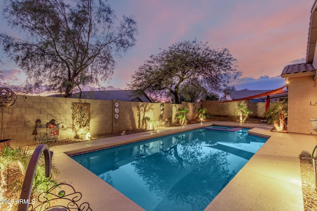 view of pool at dusk