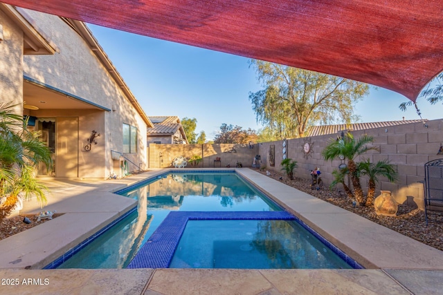 view of swimming pool with an in ground hot tub