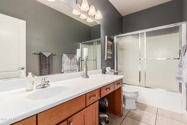 full bathroom with tile patterned flooring, vanity, shower / bath combination with glass door, and toilet