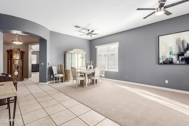 carpeted dining room featuring ceiling fan