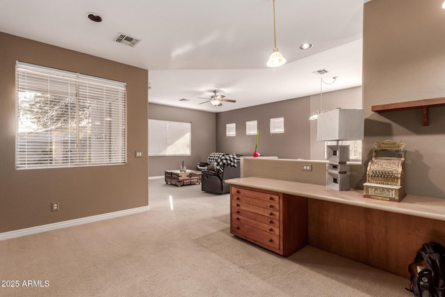 kitchen featuring hanging light fixtures, light colored carpet, and ceiling fan