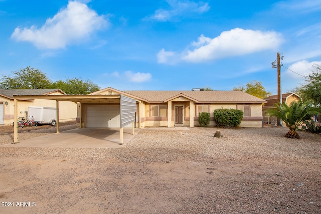 ranch-style home featuring a garage and a carport