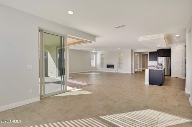 unfurnished living room with light tile patterned flooring