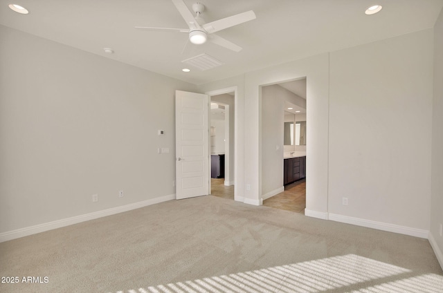 carpeted spare room featuring ceiling fan