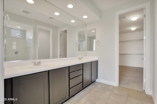 bathroom with vanity, tile patterned floors, and a shower