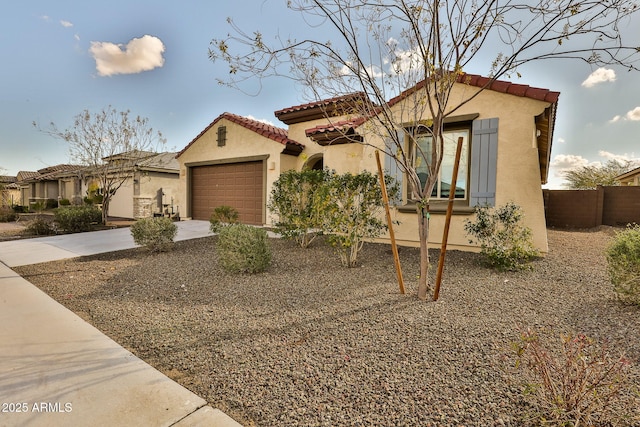 mediterranean / spanish-style home with a garage