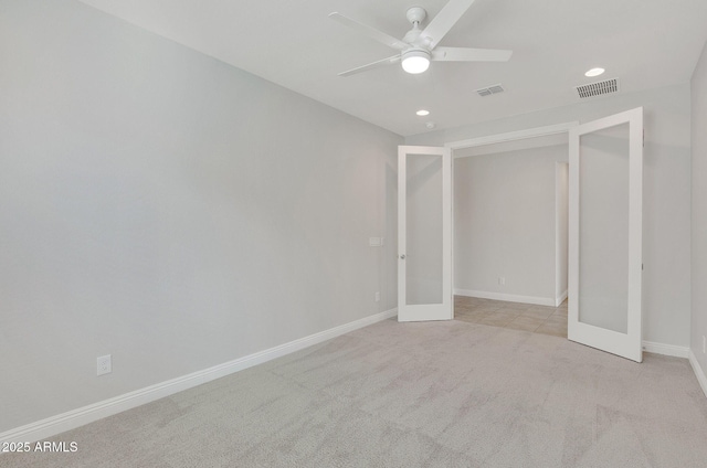 unfurnished bedroom with light carpet, ceiling fan, and french doors