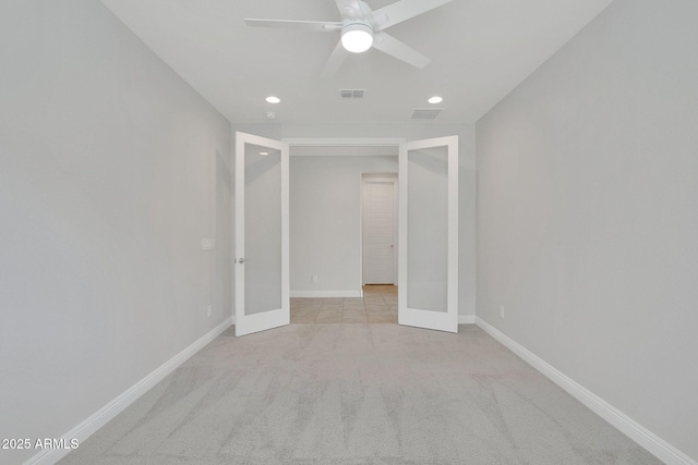 unfurnished bedroom with french doors, ceiling fan, and light colored carpet