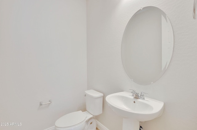 bathroom featuring toilet and sink