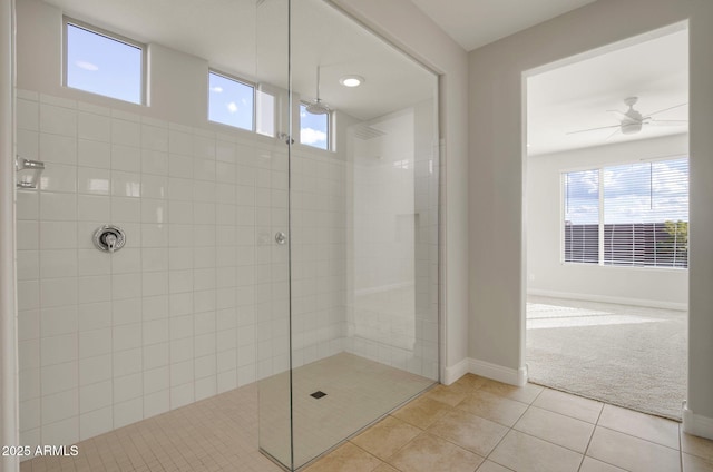 bathroom featuring tiled shower and tile patterned flooring