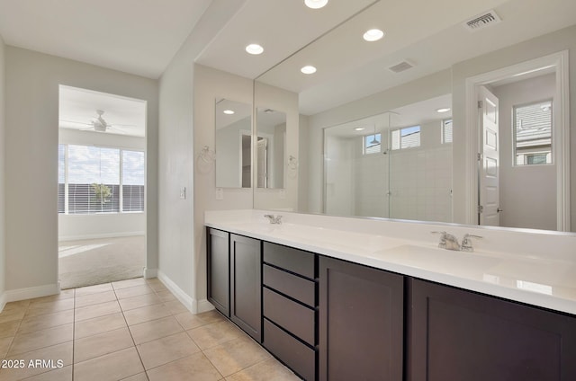 bathroom with tile patterned flooring, a shower, vanity, and ceiling fan