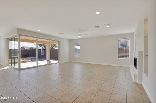 empty room featuring light tile patterned floors and ceiling fan