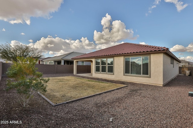 rear view of property with a patio and a lawn