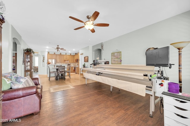 playroom with arched walkways, ceiling fan, recessed lighting, and light wood-style floors