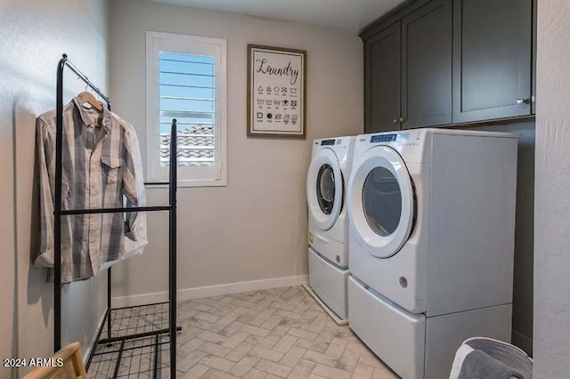 washroom with cabinets and washer and clothes dryer