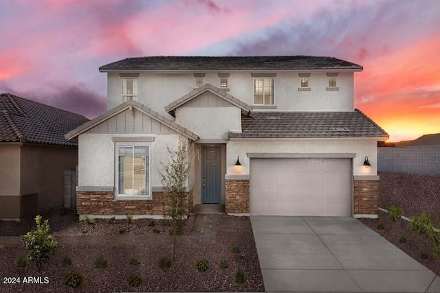 26982 N 168th Ln, Surprise, AZ 85387 - view of front facade featuring a garage, driveway, stucco siding, stone siding, and a shingled roof