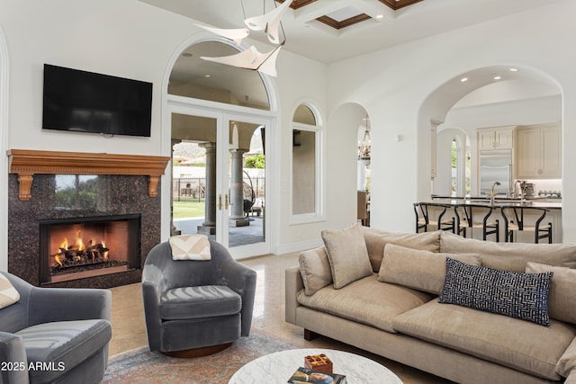 10754 E Laurel Ln, Scottsdale, AZ 85259 - living room featuring healthy amount of natural light, recessed lighting, a towering ceiling, coffered ceiling, and a high end fireplace