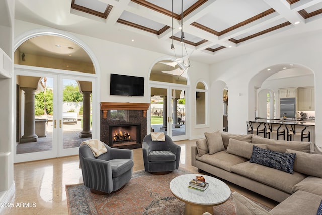 10754 E Laurel Ln, Scottsdale, AZ 85259 - living room featuring french doors, plenty of natural light, coffered ceiling, beamed ceiling, and a towering ceiling