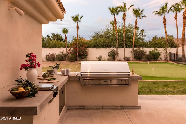 10754 E Laurel Ln, Scottsdale, AZ 85259 - fenced backyard with exterior kitchen, a putting area, and a patio