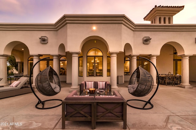 10754 E Laurel Ln, Scottsdale, AZ 85259 - patio terrace at dusk featuring an outdoor hangout area and a patio area