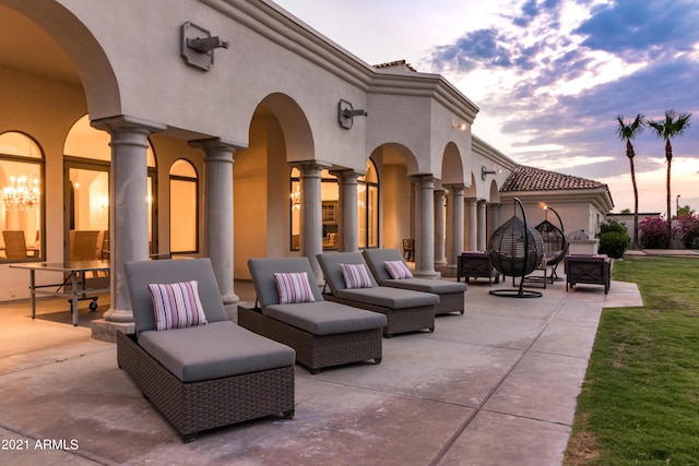10754 E Laurel Ln, Scottsdale, AZ 85259 - patio terrace at dusk featuring a patio area, outdoor lounge area, and a yard