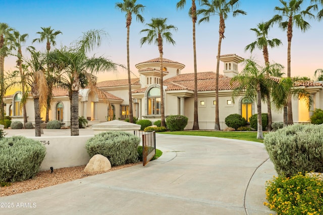 10754 E Laurel Ln, Scottsdale, AZ 85259 - view of front of home with stucco siding, a tiled roof, and curved driveway