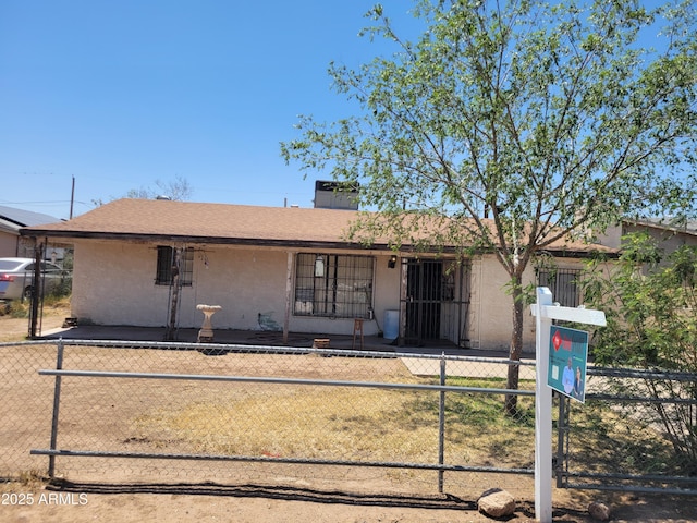 ranch-style home featuring stucco siding and a chimney